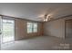 Carpeted living room with natural light, ceiling fan, and entrance to a porch at 105 Peridot Dr, Statesville, NC 28625