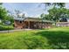 View of backyard with patio, chain link fence and brick exterior at 1094 Curve View Rd, Lincolnton, NC 28092