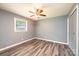 Cozy bedroom with wood-look flooring, window, and ceiling fan, perfect for restful nights at 1094 Curve View Rd, Lincolnton, NC 28092