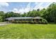 Charming single story home featuring a classic brick exterior and well-manicured lawn and landscape at 1094 Curve View Rd, Lincolnton, NC 28092
