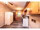 Charming kitchen features wood cabinets, a white refrigerator, and dark grey floors at 1094 Curve View Rd, Lincolnton, NC 28092