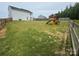 Fenced backyard with a playhouse and swing set at 110 Browband St, Troutman, NC 28166