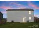 Backyard featuring a well-maintained lawn, back patio, and a view of the home's exterior at 110 Browband St, Troutman, NC 28166