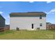 Backyard featuring a well-maintained lawn, back patio, and a view of the home's exterior at 110 Browband St, Troutman, NC 28166
