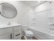 Clean bathroom with shower-tub combo, single sink vanity and modern fixtures at 110 Browband St, Troutman, NC 28166