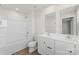 Bathroom featuring a double sink vanity, bath tub, and contemporary fixtures in a bright space at 110 Browband St, Troutman, NC 28166
