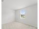 Neutral bedroom featuring carpet flooring and a window with natural light at 110 Browband St, Troutman, NC 28166