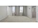 Spacious bedroom featuring plush carpet, neutral walls, and natural light from the two windows at 110 Browband St, Troutman, NC 28166