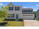 Two-story home with light gray siding, dark blue shutters, well-manicured lawn and two car garage at 110 Browband St, Troutman, NC 28166