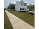 Charming two-story home featuring a well-manicured lawn and a side walk at 110 Browband St, Troutman, NC 28166