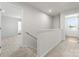 Upstairs hallway with carpet flooring and natural light coming in from a window at 110 Browband St, Troutman, NC 28166