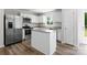 Modern kitchen with white cabinets, granite countertops, stainless steel appliances, and a center island at 110 Browband St, Troutman, NC 28166