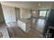Open concept kitchen with a kitchen island with granite countertops and stainless appliances at 110 Browband St, Troutman, NC 28166