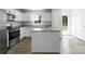 Bright kitchen featuring white cabinets, granite countertops, stainless steel appliances, and a center island at 110 Browband St, Troutman, NC 28166
