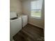 Bright laundry room with washer, dryer, and a window at 110 Browband St, Troutman, NC 28166