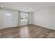 Bright living room features hardwood floors and large window at 110 Browband St, Troutman, NC 28166