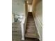 Carpeted stairs leading up and view of the open concept kitchen and living room at 110 Browband St, Troutman, NC 28166