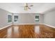 Large bedroom features hardwood flooring, a decorative ceiling fan, and two windows at 110 Colville Rd, Mooresville, NC 28117
