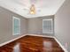 Well-lit bedroom showcases a ceiling fan, large windows, and hardwood floors at 110 Colville Rd, Mooresville, NC 28117