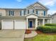 Charming two-story home featuring a welcoming front porch, two-car garage, and blue shutters at 110 Colville Rd, Mooresville, NC 28117