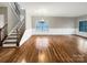Spacious living room featuring hardwood floors, wainscoting, and large windows at 110 Colville Rd, Mooresville, NC 28117