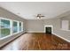 Spacious living room features hardwood flooring, a ceiling fan, and a fireplace at 110 Colville Rd, Mooresville, NC 28117