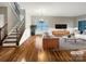 Bright living room showcases hardwood floors, a staircase, large windows and neutral wall colors at 110 Colville Rd, Mooresville, NC 28117