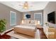 Comfortable main bedroom featuring a ceiling fan, windows, and hardwood floors at 110 Colville Rd, Mooresville, NC 28117