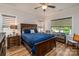 Comfortable bedroom with a wooden bed frame, ceiling fan, and a sunlit window seating area at 1109 Bunch Dr, Statesville, NC 28677