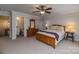 Bedroom with a wood bed frame, carpeted floors, a ceiling fan, and an en-suite bathroom at 1109 Bunch Dr, Statesville, NC 28677
