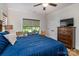 Spacious bedroom featuring wood floors, large windows, and a wooden dresser and media center at 1109 Bunch Dr, Statesville, NC 28677