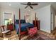 Cozy bedroom featuring a four-poster bed, ceiling fan, and natural light from the windows at 1109 Bunch Dr, Statesville, NC 28677
