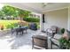 Charming covered patio with stone floor, outdoor dining set, grill and cushioned seating area at 1109 Bunch Dr, Statesville, NC 28677