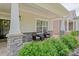 Cozy front porch sitting area with stone pillars and verdant landscaping at 1109 Bunch Dr, Statesville, NC 28677