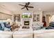 Spacious living room with fireplace, custom built-ins, and ceiling fan at 1109 Bunch Dr, Statesville, NC 28677