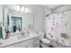 Bright bathroom featuring a vanity with marble countertops and a shower/tub with a floral curtain at 122 A Deer Brook Dr # A, Shelby, NC 28150