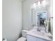 Elegant powder room features a white vanity and a modern, lighted mirror at 122 A Deer Brook Dr # A, Shelby, NC 28150