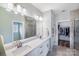 Bright bathroom features double sinks, a large mirror, and a tile shower with glass door at 122 A Deer Brook Dr # A, Shelby, NC 28150