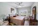 Cozy bedroom featuring a comfortable bed, wood floors, a ceiling fan, and bright natural light at 122 A Deer Brook Dr # A, Shelby, NC 28150