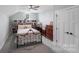Cozy bedroom featuring built-in shelving and a charming wrought iron bed frame at 122 A Deer Brook Dr # A, Shelby, NC 28150