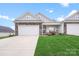 Charming home featuring a stone and siding exterior with a well-manicured front yard and a two-car garage at 122 A Deer Brook Dr # A, Shelby, NC 28150