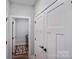 Bright hallway with a view of the laundry room and a set of large white pantry doors at 122 A Deer Brook Dr # A, Shelby, NC 28150