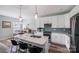 Modern kitchen featuring white cabinetry, a center island, and stainless steel appliances with view to dining area at 122 A Deer Brook Dr # A, Shelby, NC 28150
