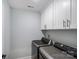 Laundry room features modern washer and dryer and white storage cabinets above at 122 A Deer Brook Dr # A, Shelby, NC 28150