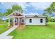 Charming single-story home with a covered front porch, well-manicured lawn and sidewalk to the front door at 1244 Bob Falls Rd, Shelby, NC 28150