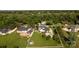 Aerial view showcases a home with a pool and well-manicured grounds, surrounded by mature trees and neighboring properties at 129 Renaissance Pl, Statesville, NC 28625