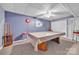 Basement recreational space includes a pool table, and a simple ceiling fan at 129 Renaissance Pl, Statesville, NC 28625