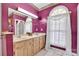 Bathroom with double sink vanity, large mirror, and window with flowing white curtains at 129 Renaissance Pl, Statesville, NC 28625