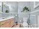 Cozy bathroom with vanity, light fixtures, toilet, and soft blue walls at 129 Renaissance Pl, Statesville, NC 28625