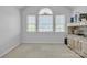 Well-lit bedroom with carpet, three windows, and a neutral color scheme at 129 Renaissance Pl, Statesville, NC 28625